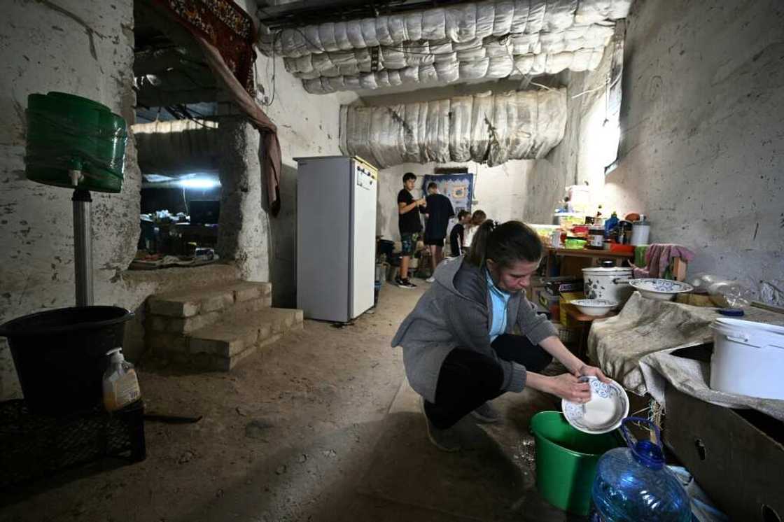 Some Saltivka residents have moved into a cavernous, gloomy shelter below the local school Some Saltivka residents have moved into a cavernous, gloomy shelter below the local school