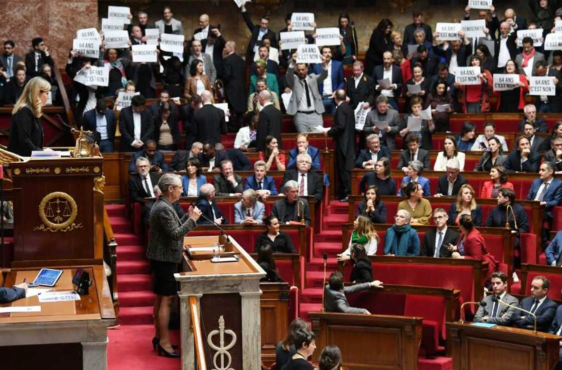 Left-wing oppositions MPs held up signs and jeered Prime Minister Elizabeth Borne as she announced the news Left-wing oppositions MPs held up signs and jeered Prime Minister Elizabeth Borne as she announced the news