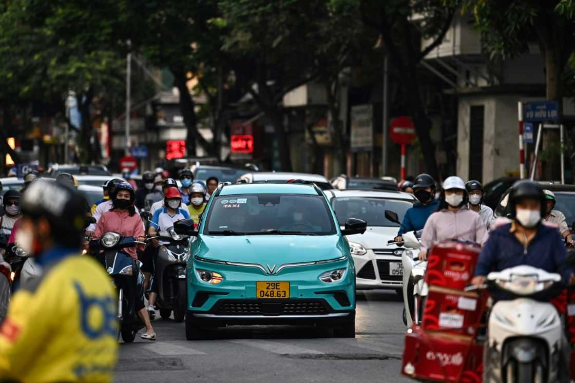 A Vinfast electric car travels down a street in Hanoi A Vinfast electric car travels down a street in Hanoi