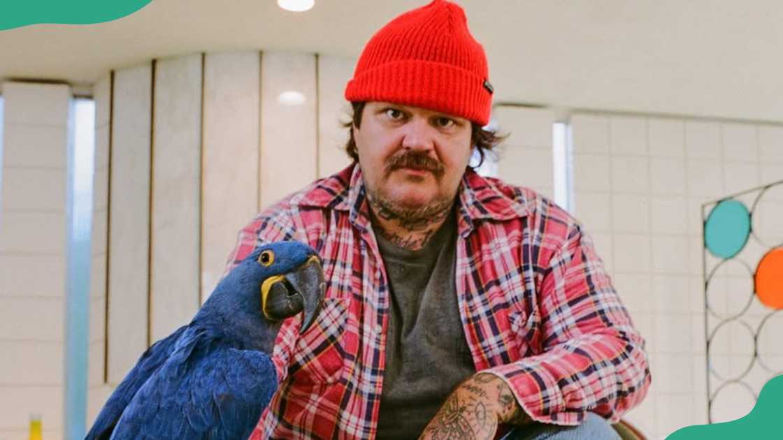 Matty Matheson holds a parrot on his arm Matty Matheson holds a parrot on his arm