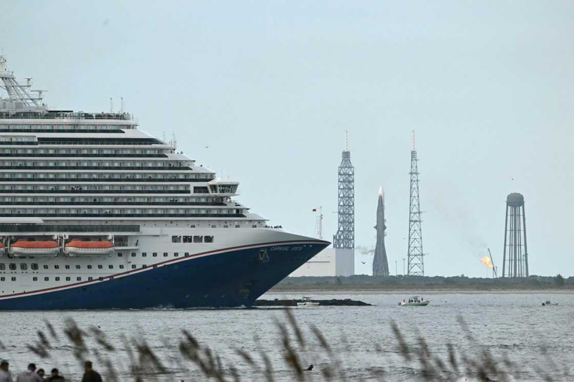 A cruise ship sails by Blue Origin's New Glenn rocket, which has scrubbed its launch for weather issues at the Space Force Station in Cape Canaveral, Florida A cruise ship sails by Blue Origin's New Glenn rocket, which has scrubbed its launch for weather issues at the Space Force Station in Cape Canaveral, Florida