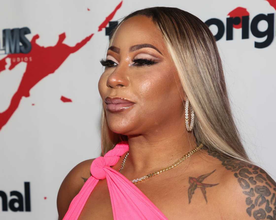 Hazel-E in a pink outfit at a red carpet.