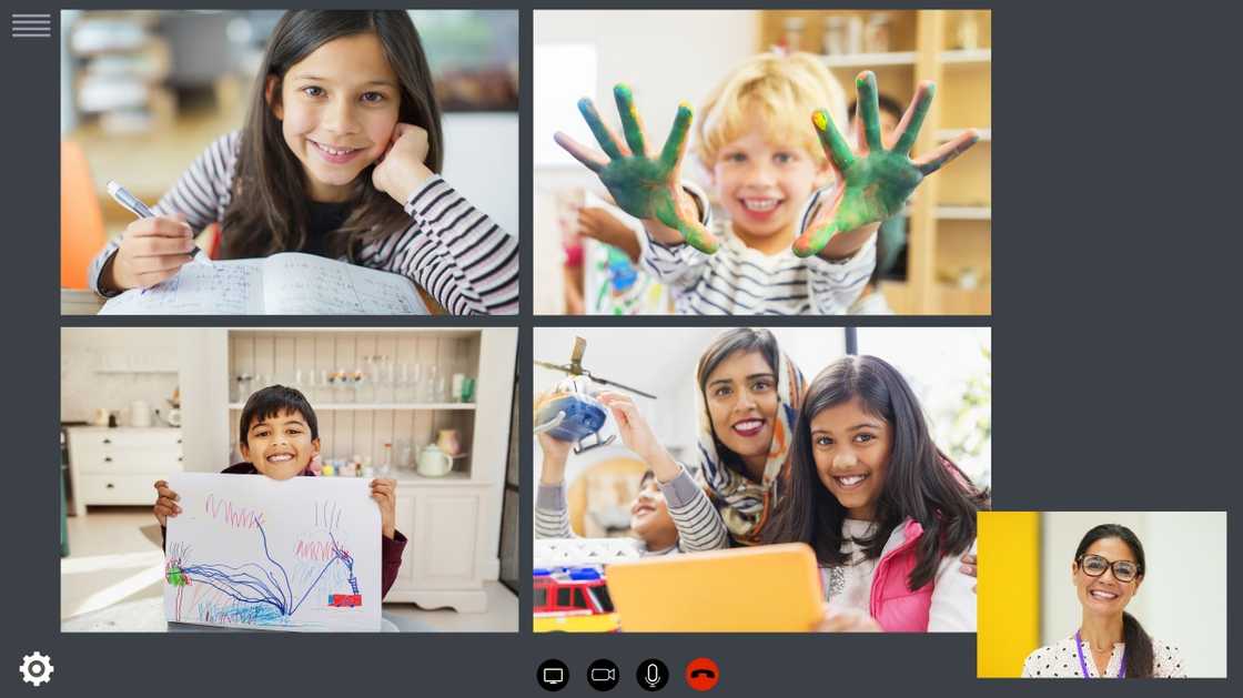 Children display their art work during a Zoom class.