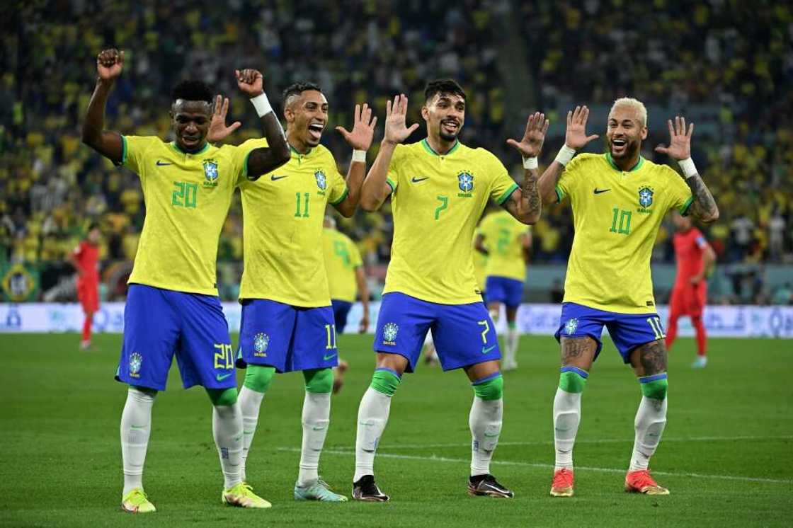 Brazil’s Neymar, right, celebrates with teammates against South Korea at the Qatar 2022 World Cup. Photo by Manu Fernandez