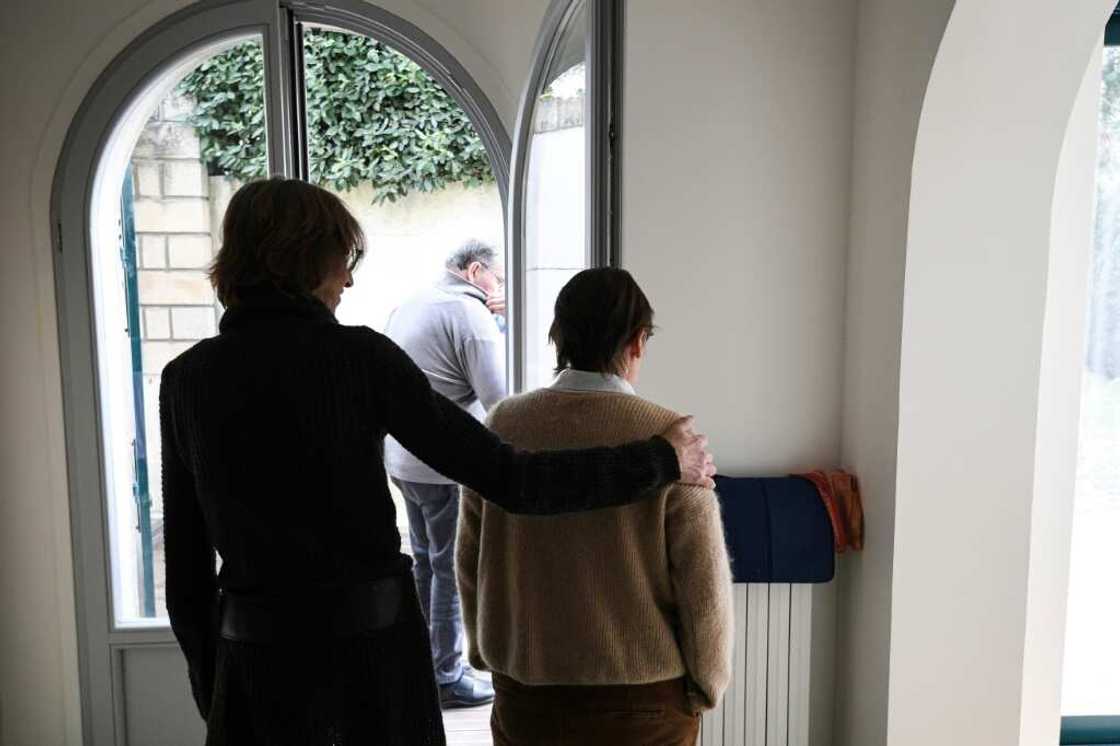 A carer helps an elderly resident - one of three alzheimer sufferers in the establishment- in a house at L'Hay-les- Roses on the outskirts of Paris A carer helps an elderly resident - one of three alzheimer sufferers in the establishment- in a house at L'Hay-les- Roses on the outskirts of Paris