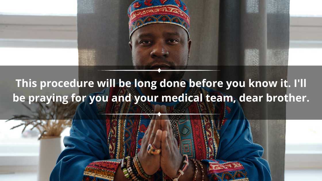 A man wearing a colourful African outfit is praying