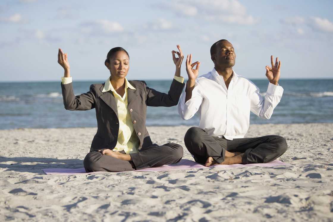 Businesspeople doing yoga and meditating.