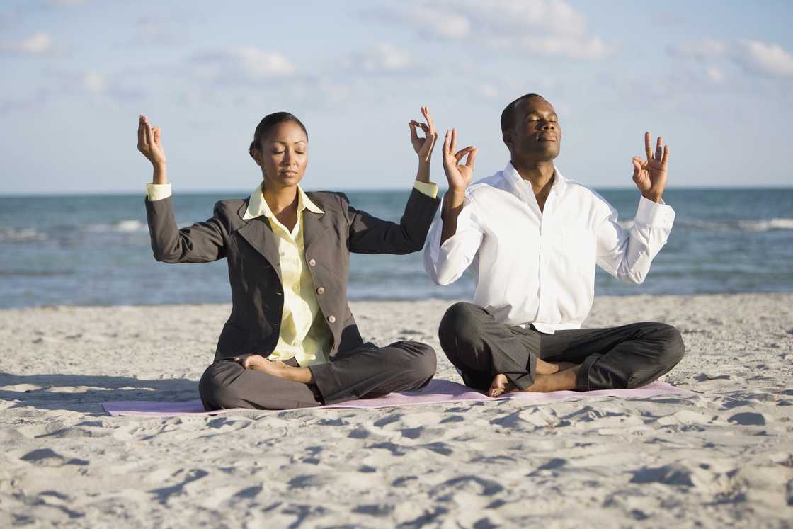 Businesspeople doing yoga and meditating. Businesspeople doing yoga and meditating.
