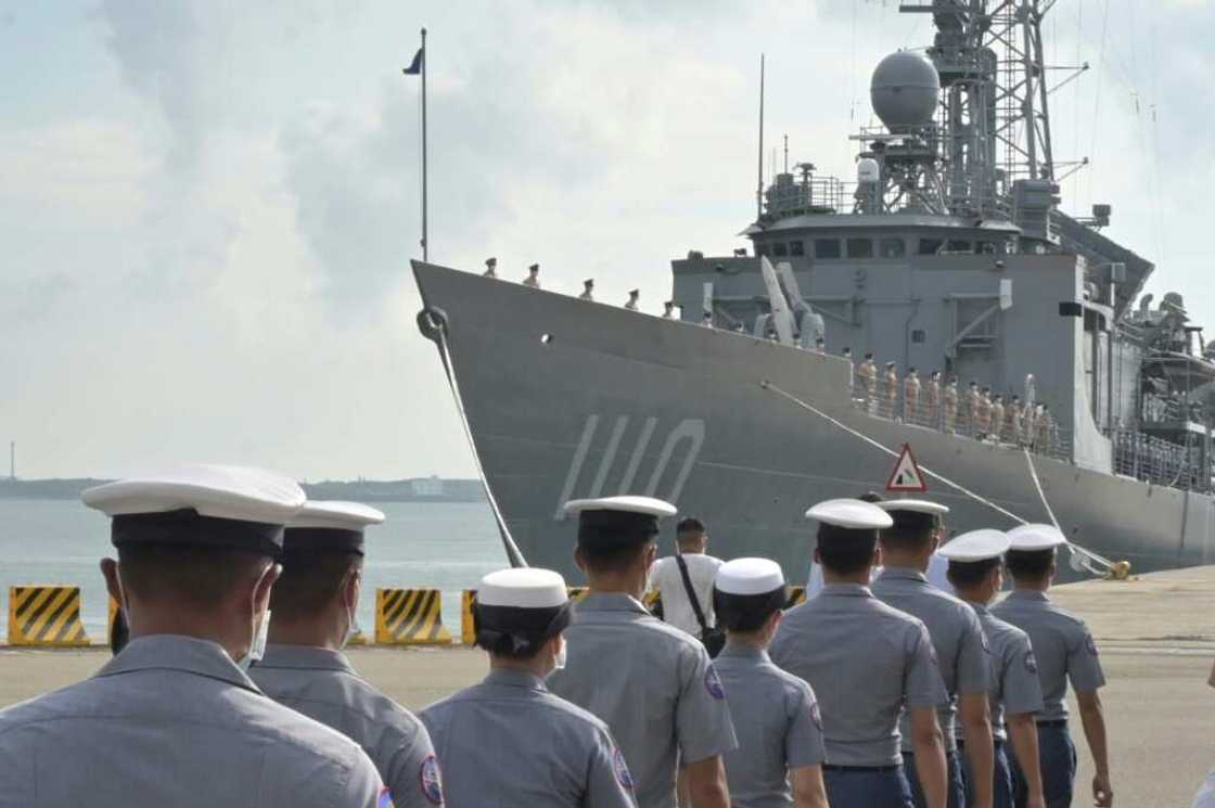 Taiwanese sailors walk in front of a frigate as President Tsai Ing-wen inspects troops on the Penghu islands amid high tensions with Beijing