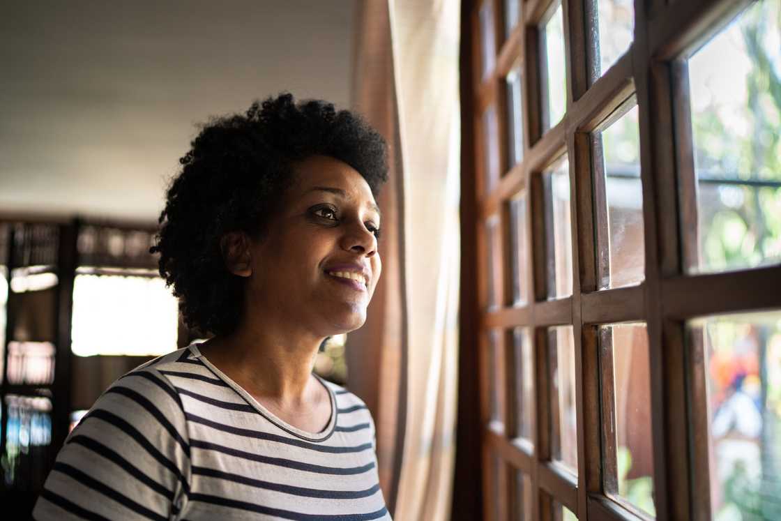 A lady reflecting by the window A lady reflecting by the window