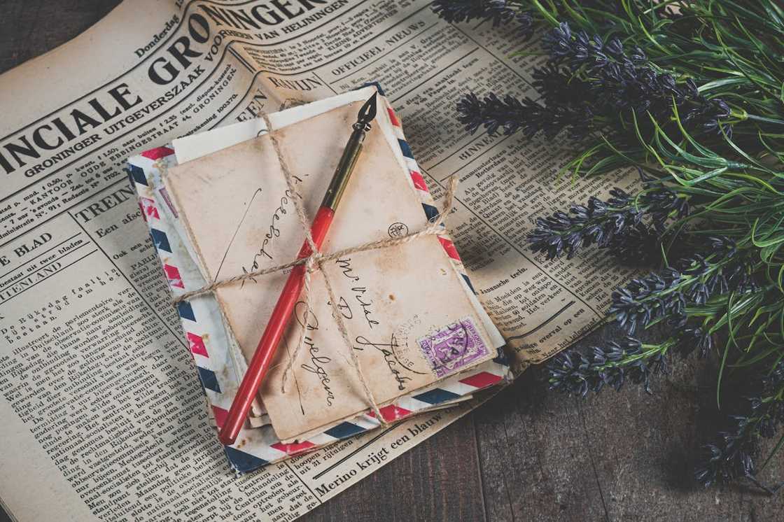 A bundle of old letters tied with a string on a newspaper. A bundle of old letters tied with a string on a newspaper.
