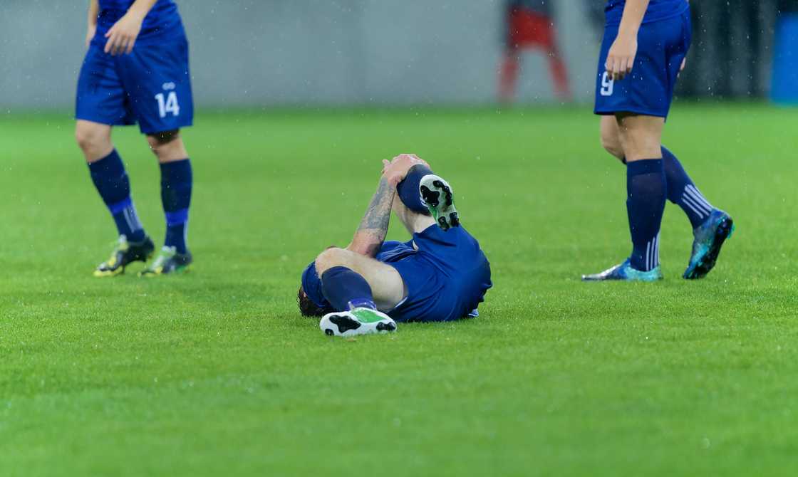 A soccer player injured after tackle during match A soccer player injured after tackle during match