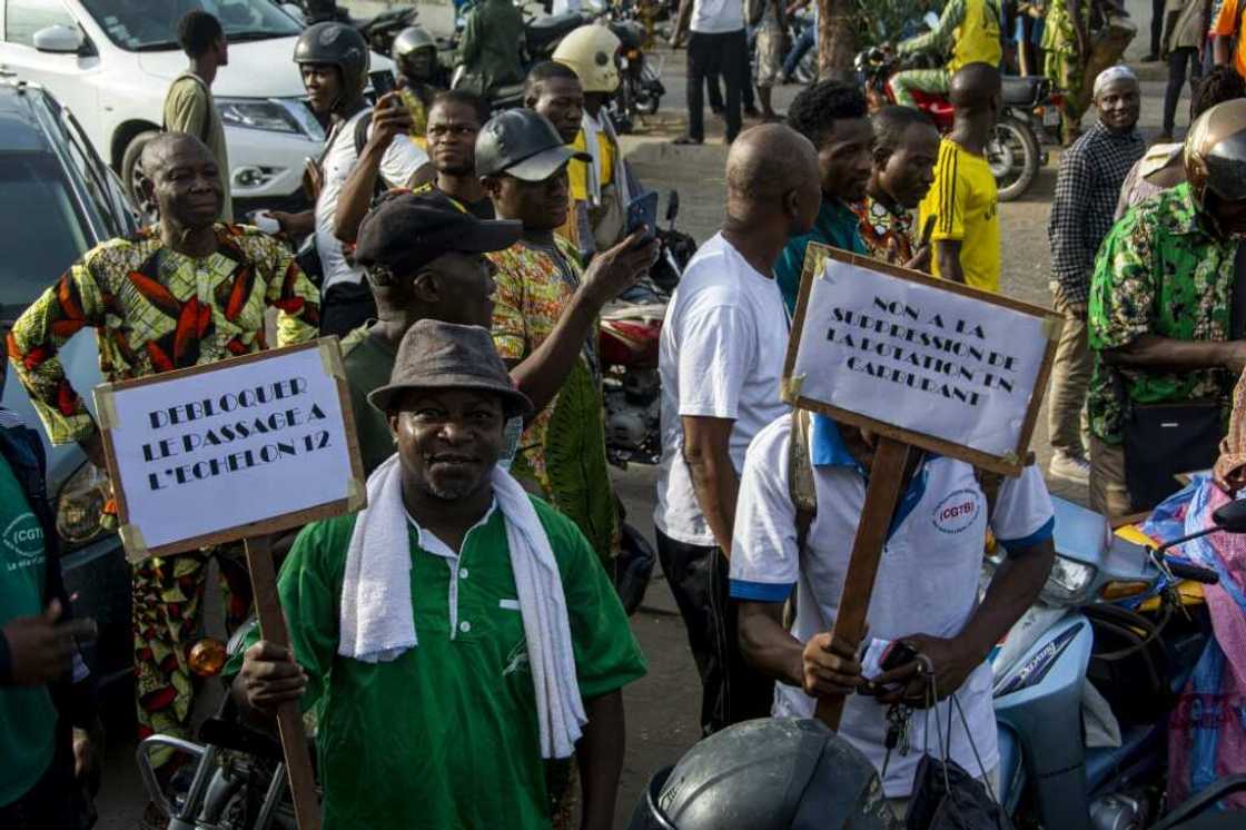 Demonstrators hold up placards during a march against the high cost of living in Cotonou, last April 27, 2024 Demonstrators hold up placards during a march against the high cost of living in Cotonou, last April 27, 2024