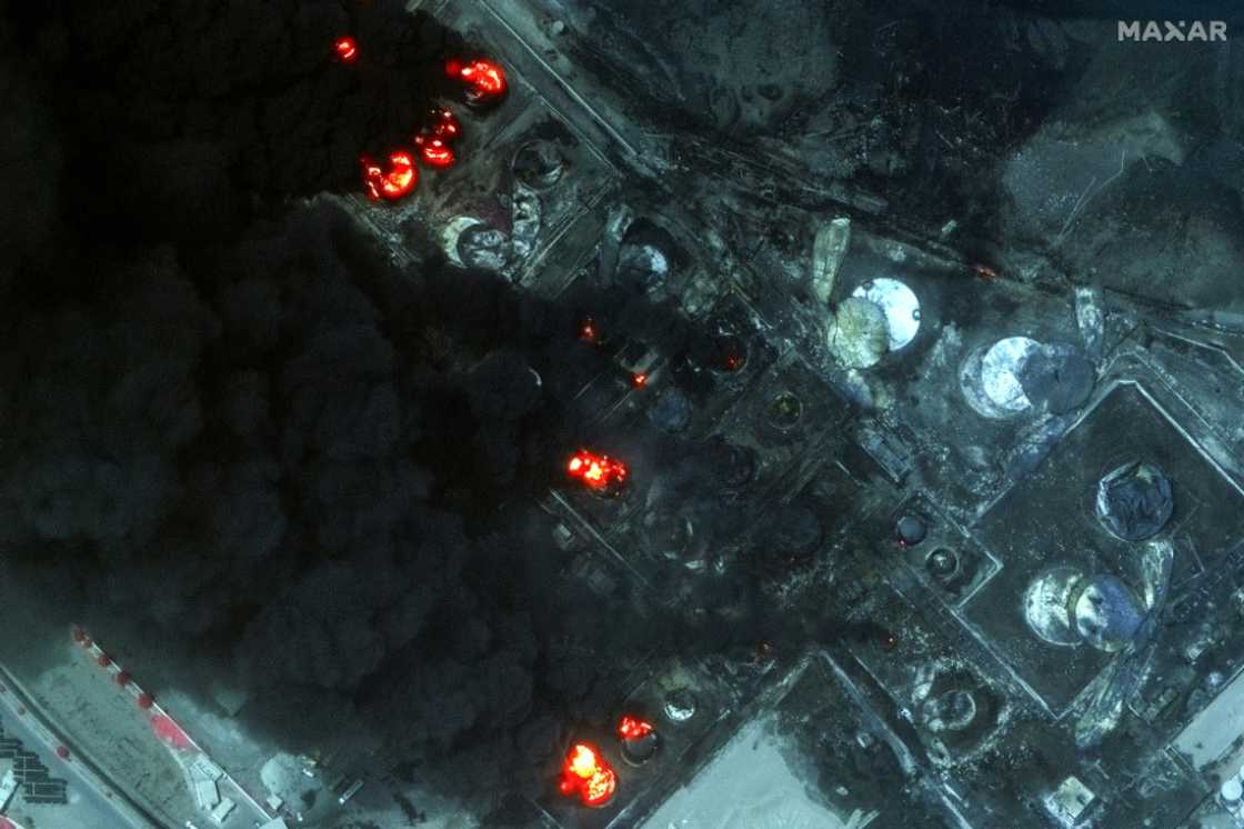 This handout satellite image released by Maxar Technologies shows burning oil tanks in the port of Yemen's Huthi-held city of Hodeida on July 21, 2024, a day after Israeli strikes