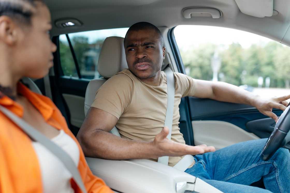 A man arguing with his girlfriend inside the car