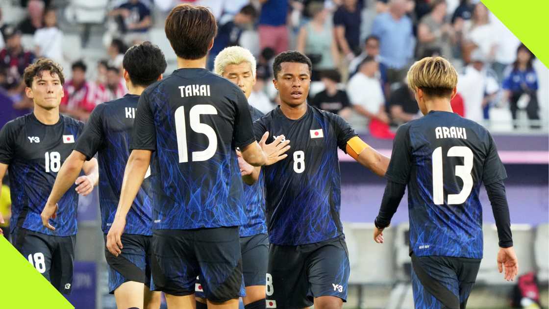 Japan players celebrate after beating Paraguay 5-0 at the Olympics.