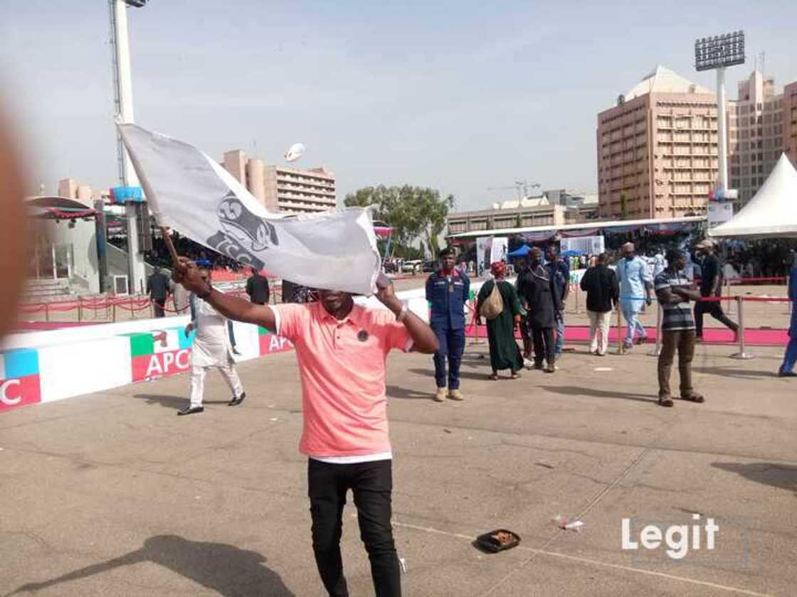 A Pro-Tinubu Supporter Waving a Flag of Bola Tinubu’s Image at the Eagle Square, Abuja. A Pro-Tinubu Supporter Waving a Flag of Bola Tinubu’s Image at the Eagle Square, Abuja.