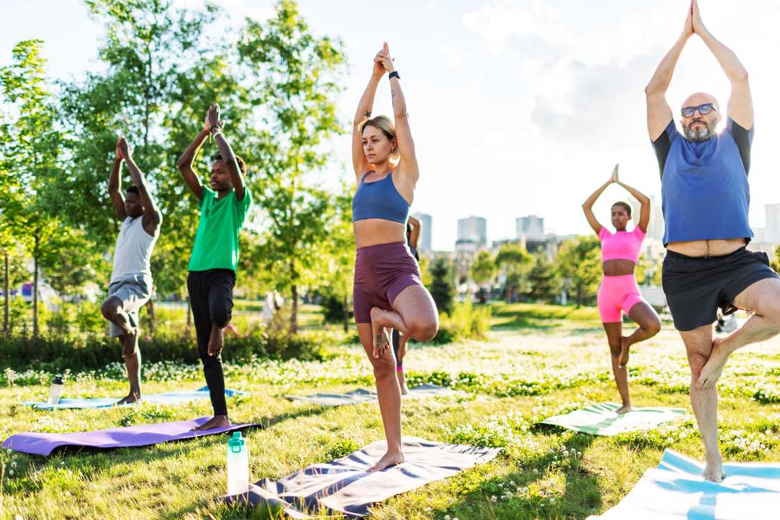 Yoga class practicing outdoors Yoga class practicing outdoors
