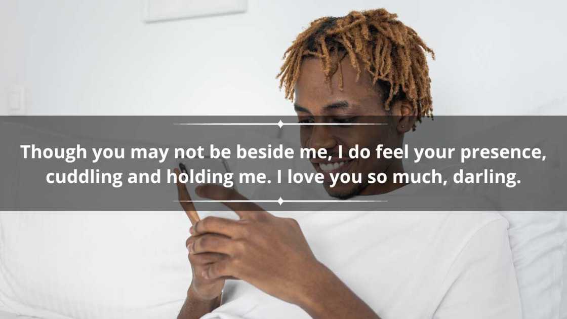 A man in dreadlocks and a white t-shirt is texting using a smartphone A man in dreadlocks and a white t-shirt is texting using a smartphone