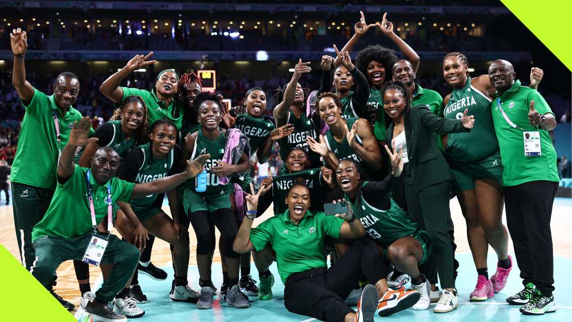 D'Tigress team and crew members celebrate after beating Canada at Paris Olympics.