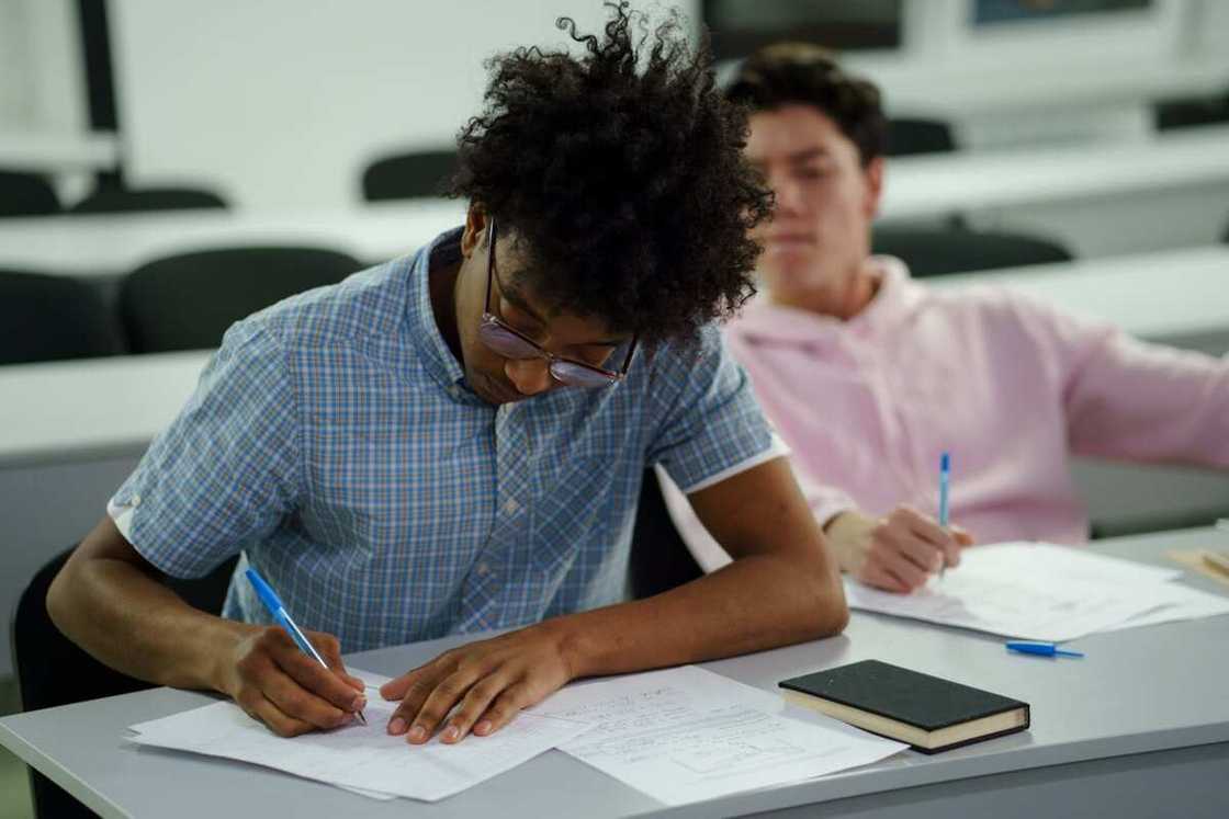 A student writing on a paper