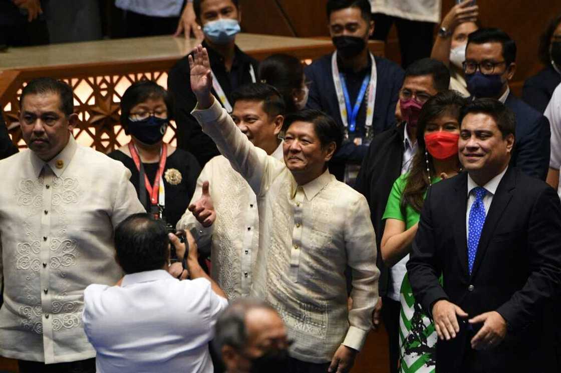 Philippine president-elect Ferdinand Marcos Jr (C) waves to supporters as he arrives for his proclamation as the country's president Philippine president-elect Ferdinand Marcos Jr (C) waves to supporters as he arrives for his proclamation as the country's president