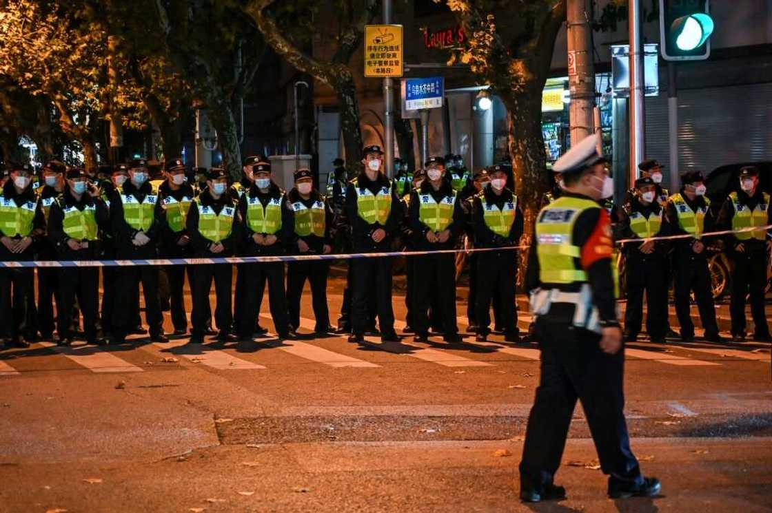 Police block Wulumuqi street in Shanghai, where protests occurred against China's zero-Covid policy