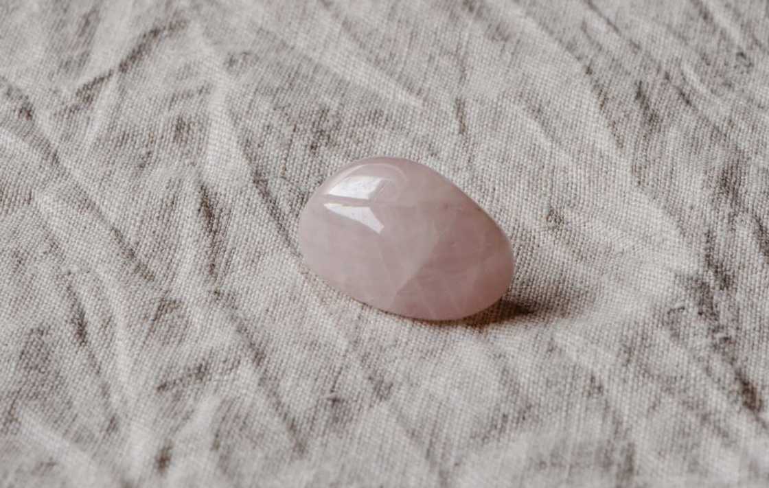 A close-up shot of a rose quartz on a piece of cloth A close-up shot of a rose quartz on a piece of cloth