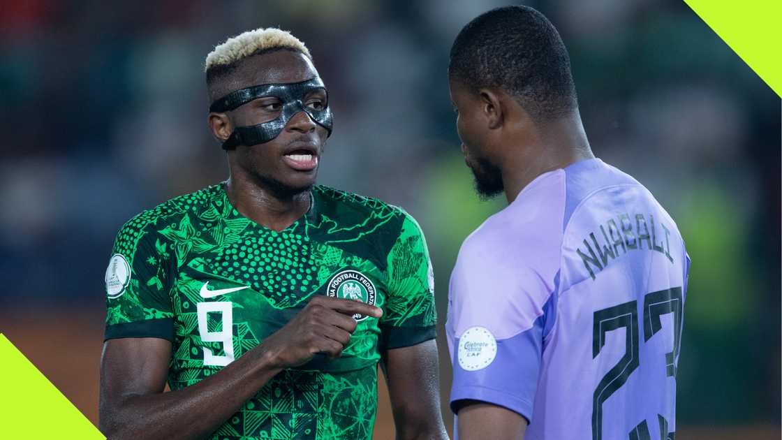 Victor Osimhen and Stanley Nwabali discussing during a AFCON 2023 match.