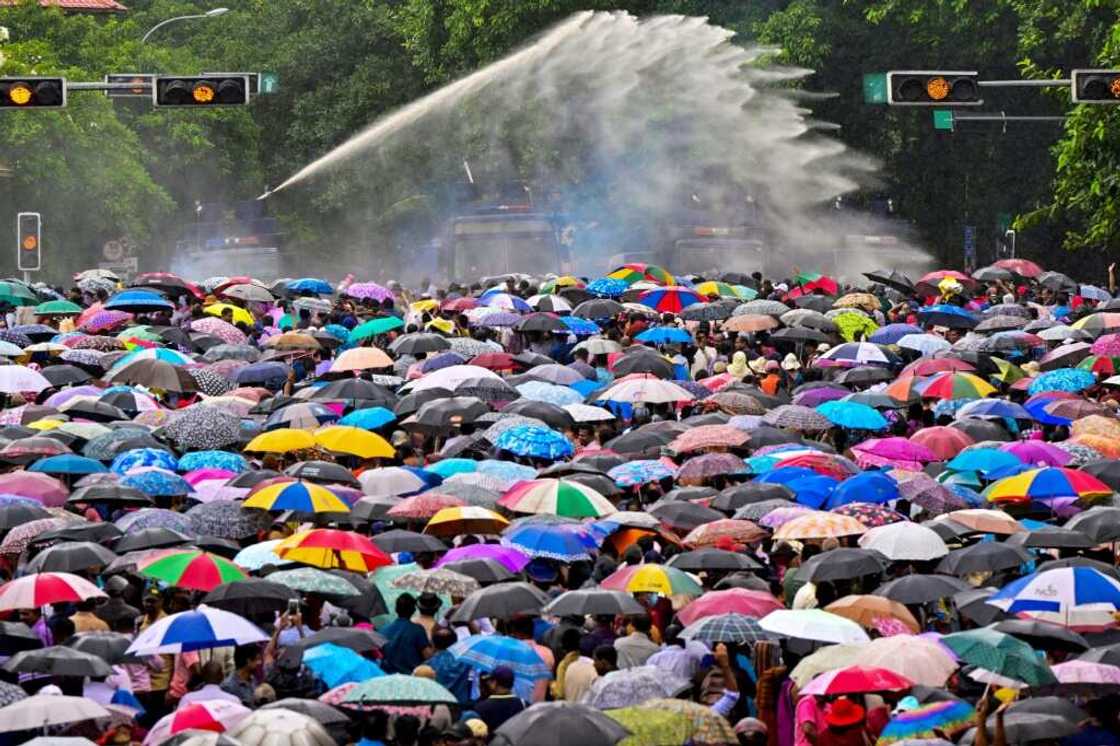 Sri Lankan police use water cannons and tear gas to disperse teachers protesting over salaries during an anti-government demonstration in Colombo on June 26