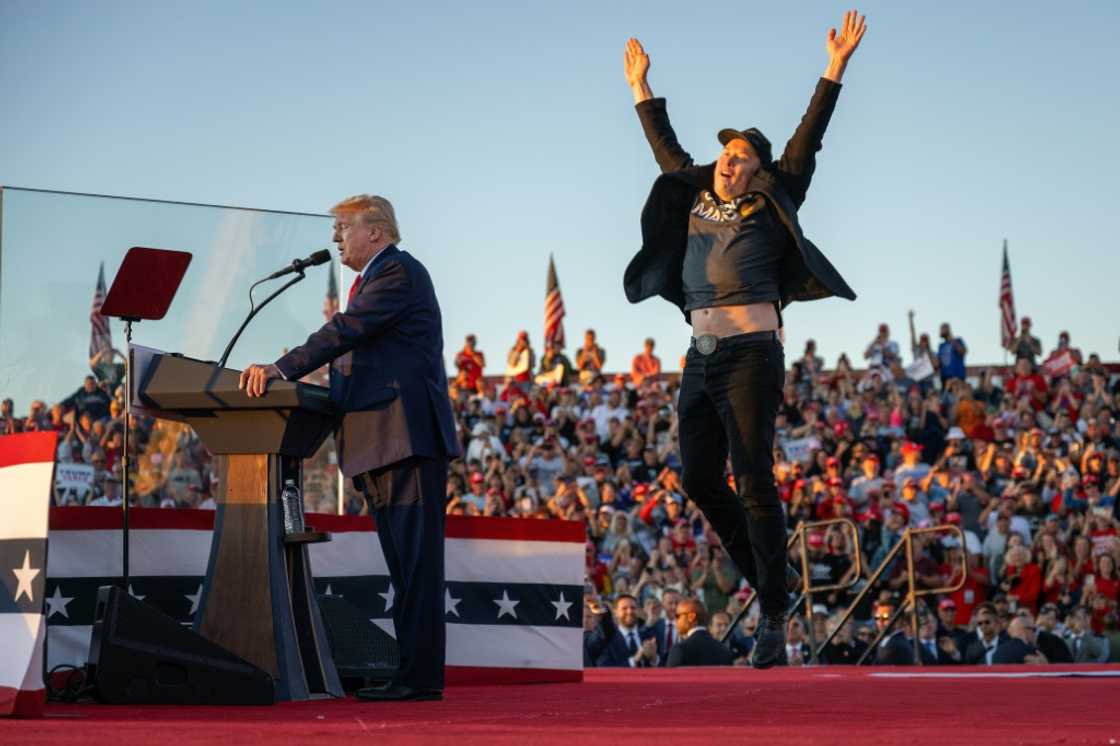 Tesla CEO Elon Musk jumps on stage as he joins former US president and Republican presidential candidate Donald Trump during a campaign rally Tesla CEO Elon Musk jumps on stage as he joins former US president and Republican presidential candidate Donald Trump during a campaign rally