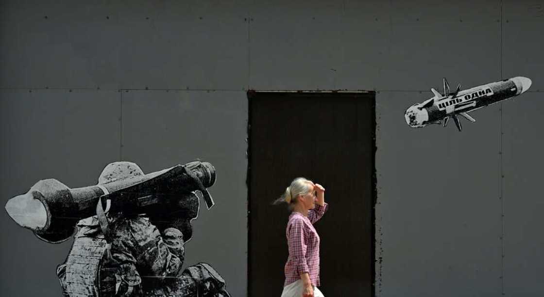 A woman walks past a mural in Kyiv depicting a Ukrainian serviceman firing a US-made Javelin anti-tank missile in July 2022 A woman walks past a mural in Kyiv depicting a Ukrainian serviceman firing a US-made Javelin anti-tank missile in July 2022