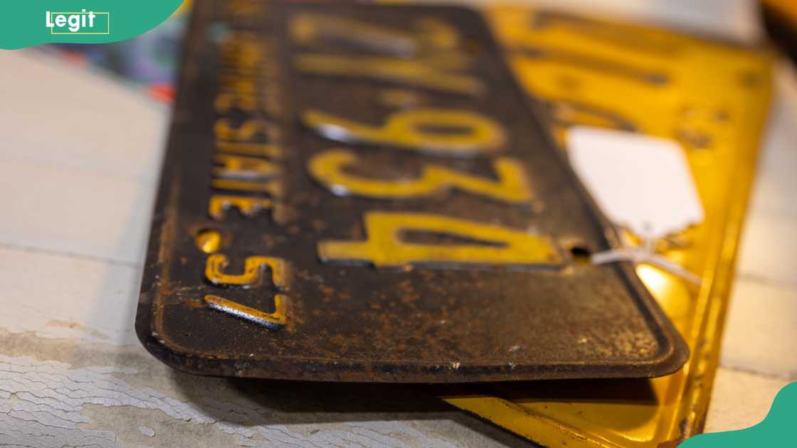 Old vehicle number plates on a table