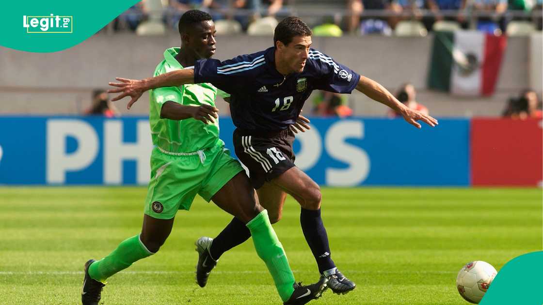 Bartholomew Ogbeche tackles Kily Gonzalez during the World Cup match between Nigeria and Argentina at the Ibaraki-Prefectural Kashima Stadium, Japan in 2002. Photo by Stu Forster