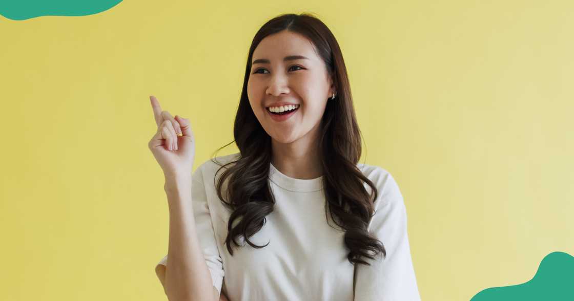 A woman raises her hand to answer a question