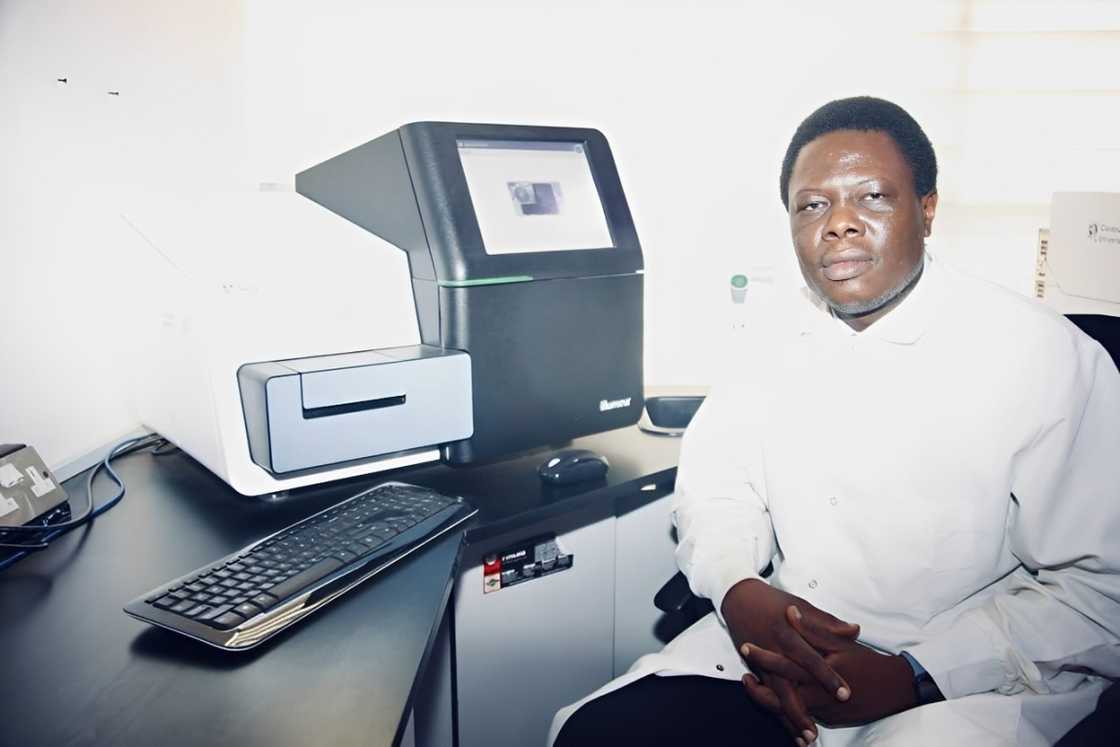 Professor Solomon Rotimi sits in front of a laboratory equipment.