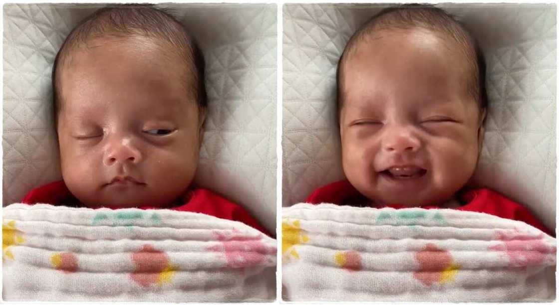 Baby smiles happily after opening his eyes.