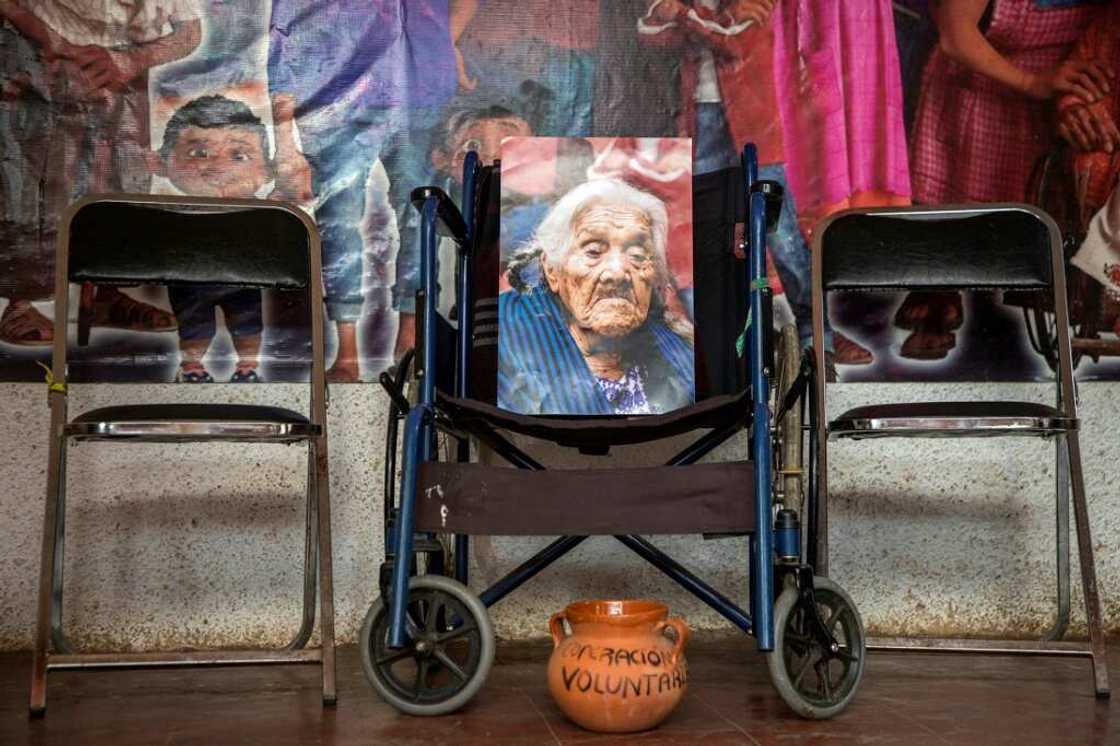 Maria Salud Ramirez is now only present in the photographs placed on her wheelchair and the altar that her family has prepared to receive her spirit on the Day of the Dead Maria Salud Ramirez is now only present in the photographs placed on her wheelchair and the altar that her family has prepared to receive her spirit on the Day of the Dead