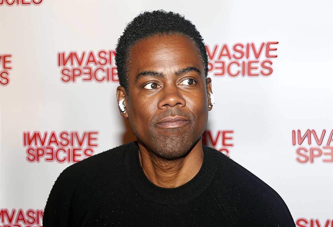 Chris Rock poses at the opening of "Invasive Species" play