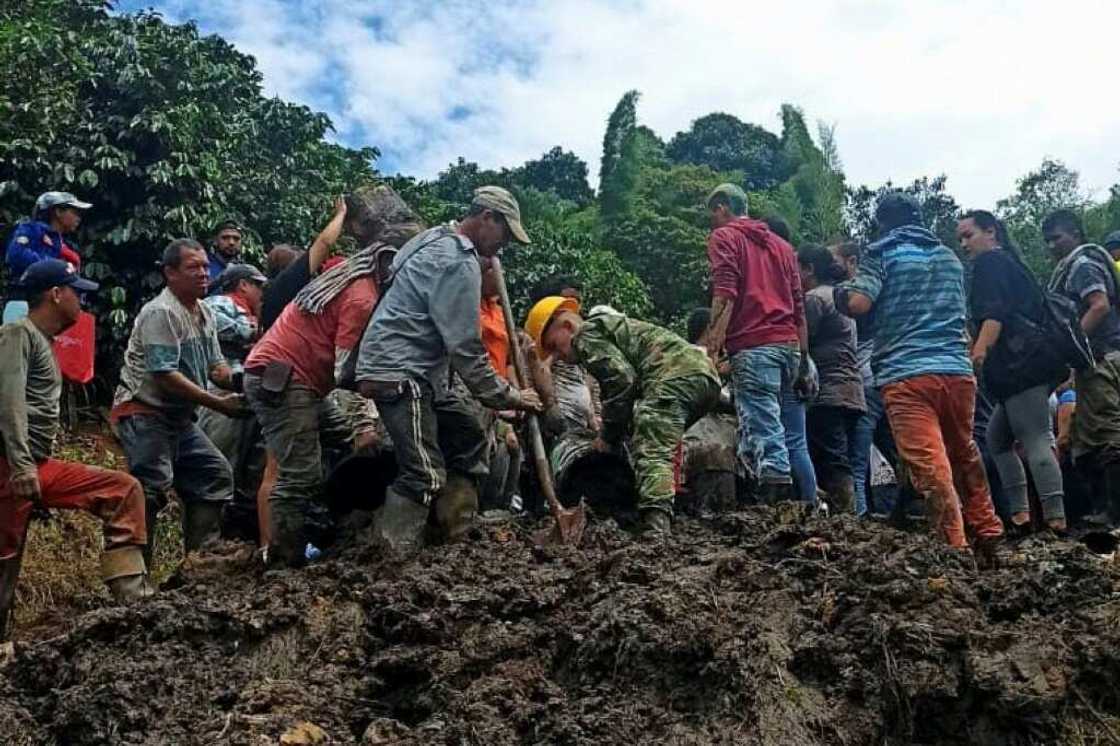 Villagers are digging through the rubble where at least eight children are believed to be trapped after a landslide buried a school Villagers are digging through the rubble where at least eight children are believed to be trapped after a landslide buried a school