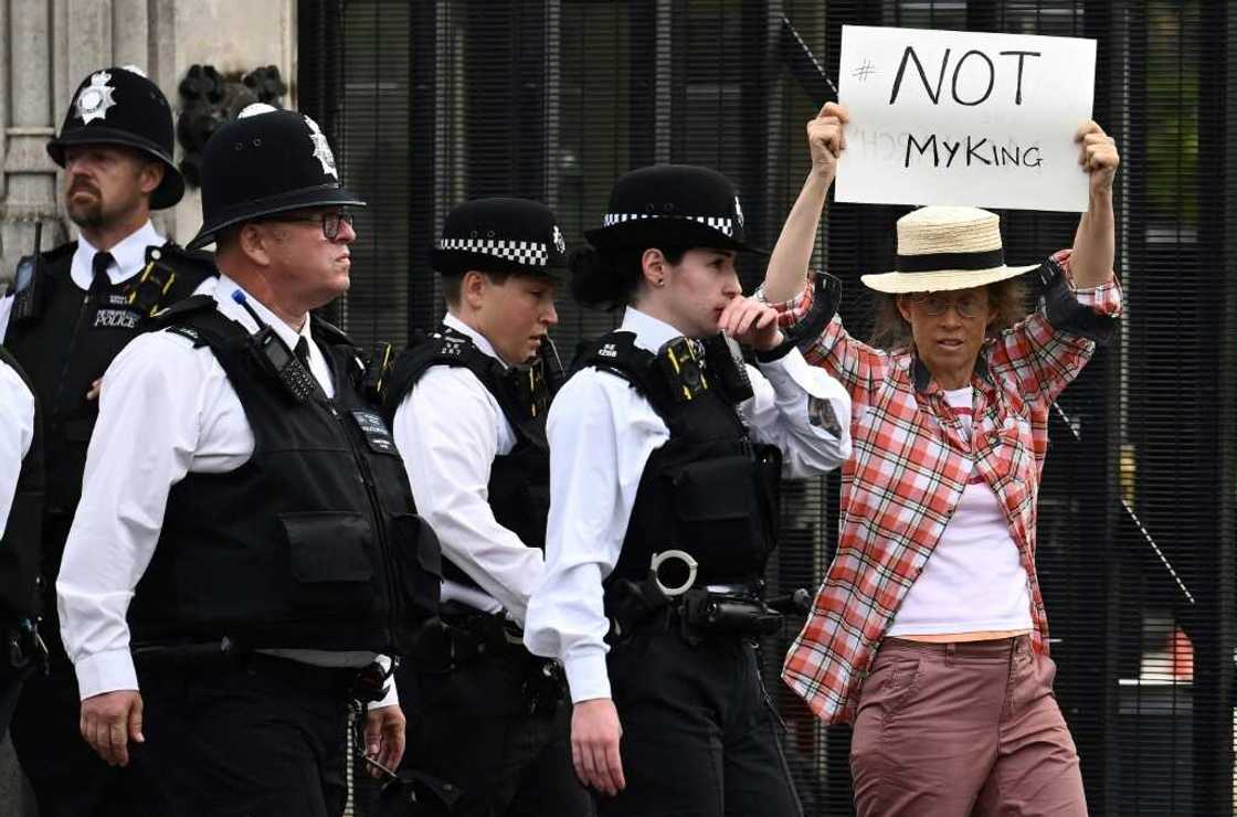 One protester was ushered away from the UK parliament for holding up a sign against King Charles III One protester was ushered away from the UK parliament for holding up a sign against King Charles III