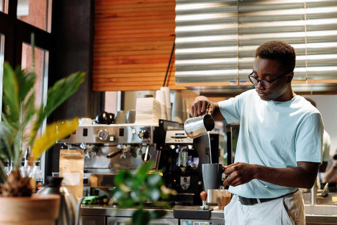 A man working in a cafe A man working in a cafe