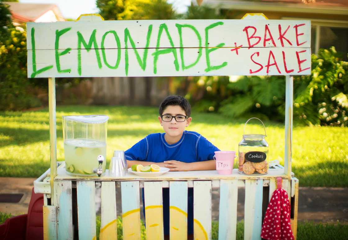 A young boy selling lemonade. A young boy selling lemonade.