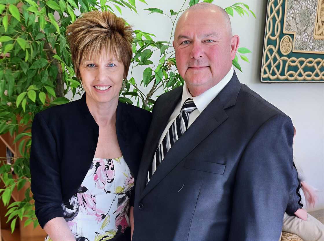 Jim poses standing with his wife, Terri Smith