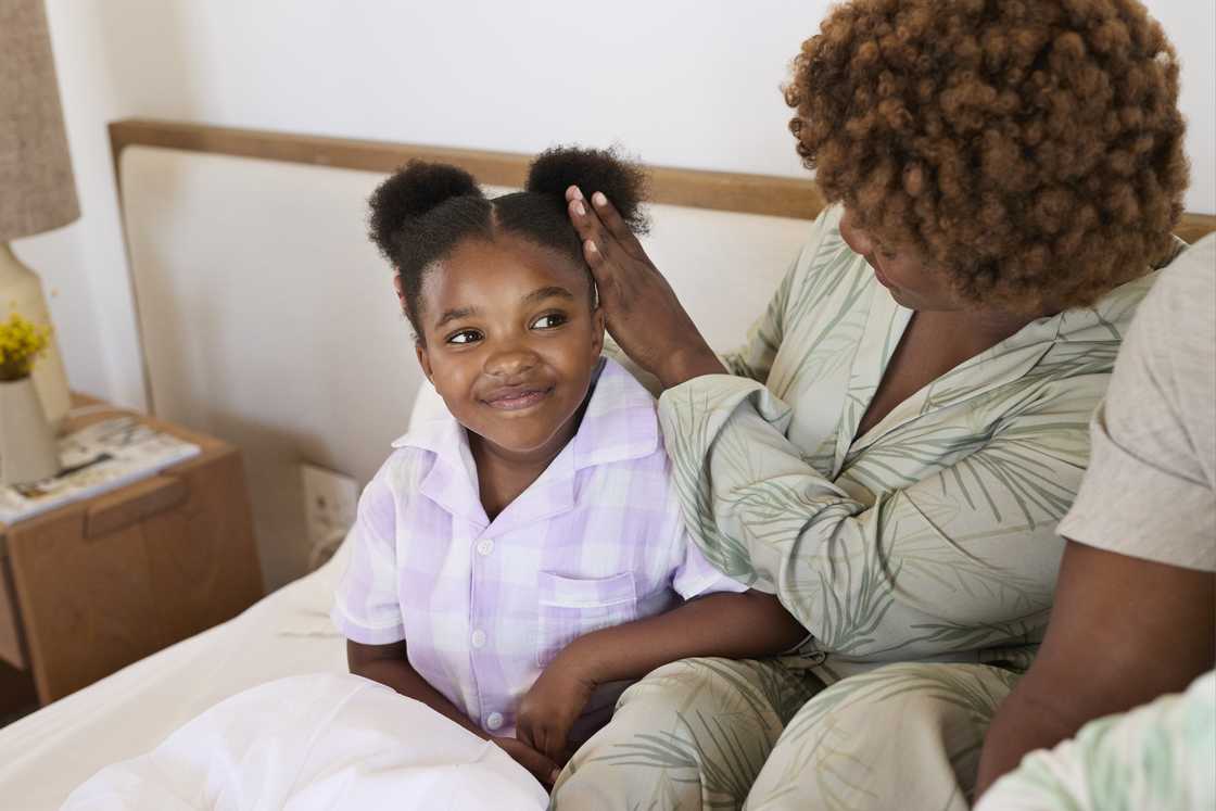 A daughter and her mother in bed A daughter and her mother in bed