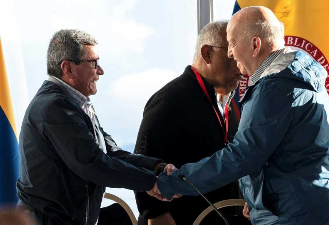 National Liberation Army (ELN) Commander Pablo Beltran (left) and government representative Otty Patino shake hands after announcing the results of the peace talks National Liberation Army (ELN) Commander Pablo Beltran (left) and government representative Otty Patino shake hands after announcing the results of the peace talks