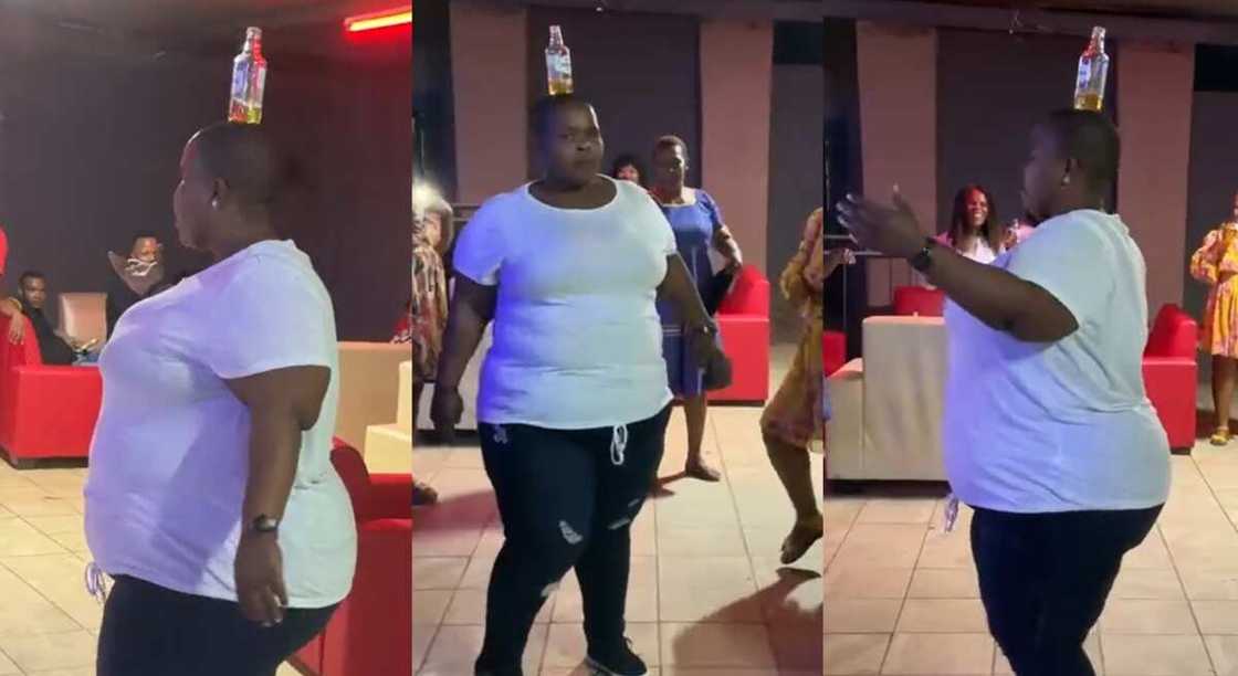 Photos of a lady dancing with a bottle on her head. Photos of a lady dancing with a bottle on her head.