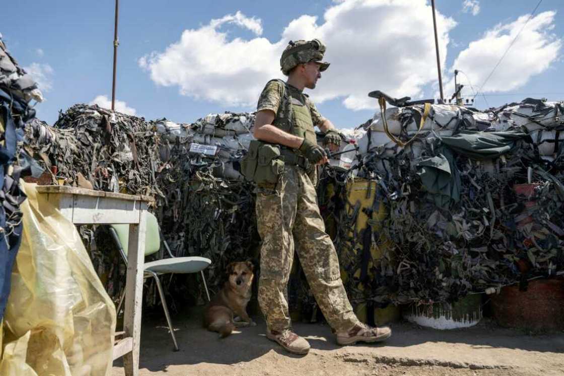 A small detachment of Ukrainian soldiers holds the position in sandbagged trenches and the wreckage of destroyed buildings A small detachment of Ukrainian soldiers holds the position in sandbagged trenches and the wreckage of destroyed buildings