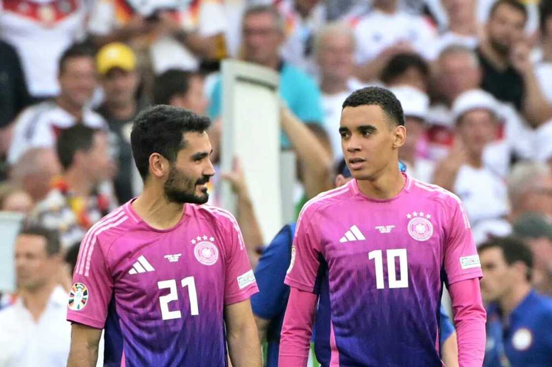 Midfielders Ilkay Gundogan Jamal Musiala in Germany's pink and purple jerseys after winning the UEFA Euro 2024 Group A football match against Hungary on June 19 Midfielders Ilkay Gundogan Jamal Musiala in Germany's pink and purple jerseys after winning the UEFA Euro 2024 Group A football match against Hungary on June 19