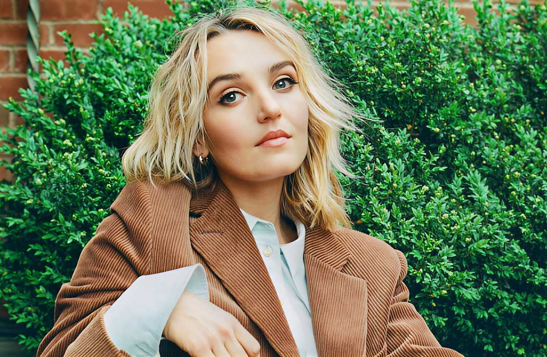 Chloe Fineman poses sitting for a magazine feature